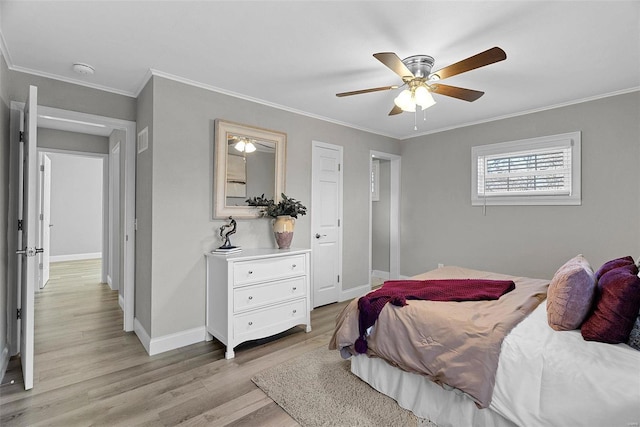 bedroom featuring baseboards, crown molding, light wood finished floors, and ceiling fan