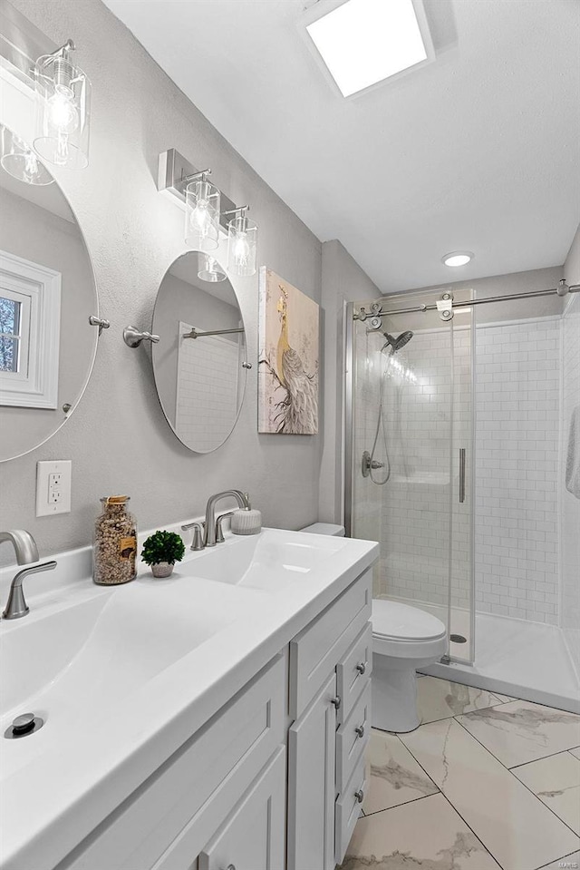 full bathroom with toilet, marble finish floor, a shower stall, and vanity