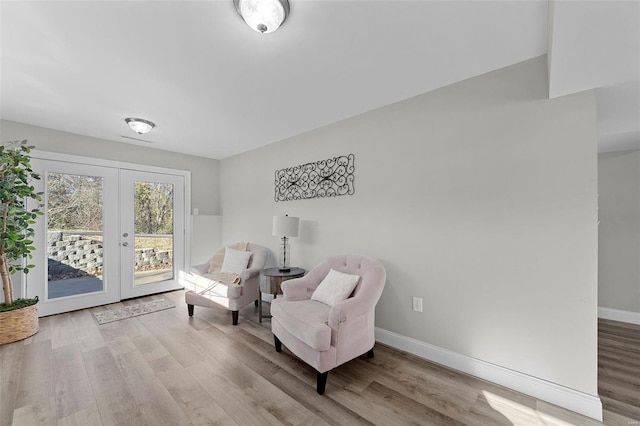 sitting room featuring french doors, wood finished floors, and baseboards