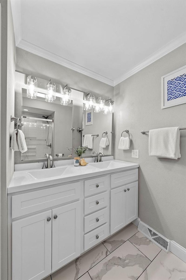 bathroom featuring baseboards, a shower with door, marble finish floor, crown molding, and a sink