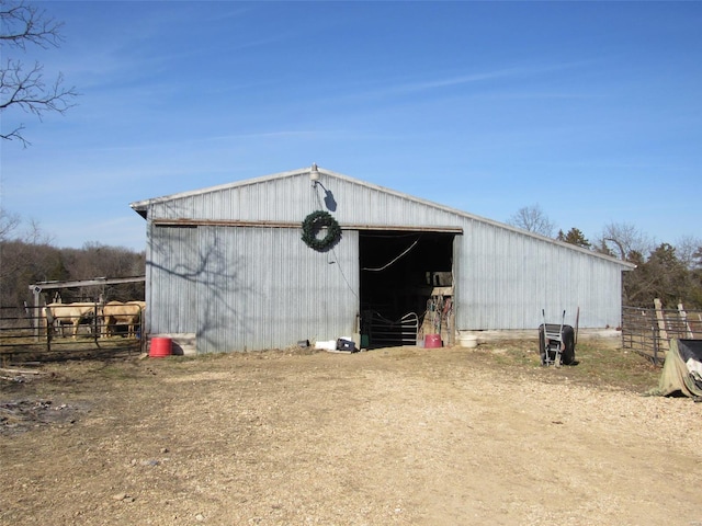 view of pole building with fence