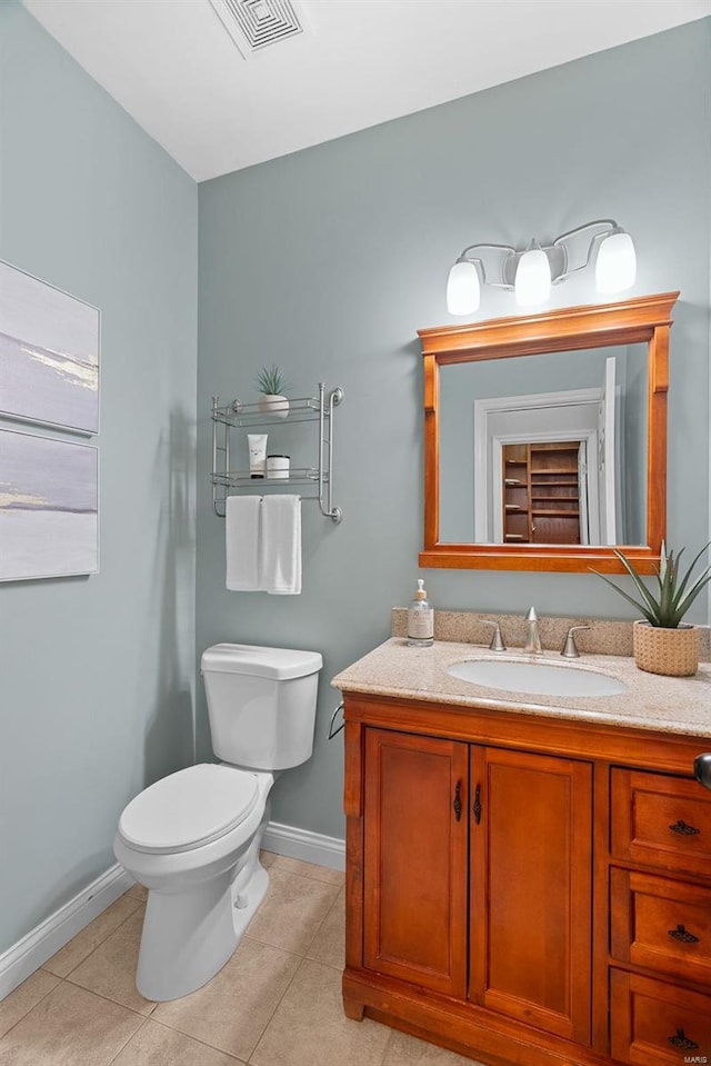 bathroom with toilet, tile patterned flooring, visible vents, and baseboards