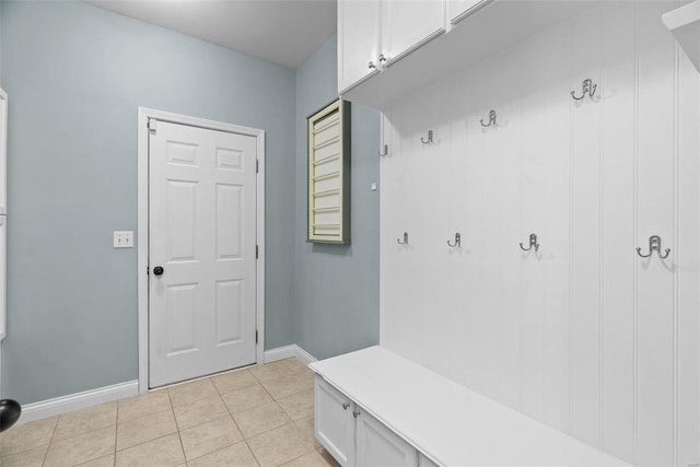 mudroom with light tile patterned flooring and baseboards