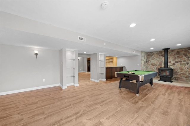 rec room featuring billiards, visible vents, baseboards, light wood-style flooring, and a wood stove