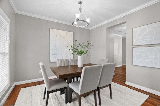 dining room featuring plenty of natural light, a notable chandelier, and wood finished floors