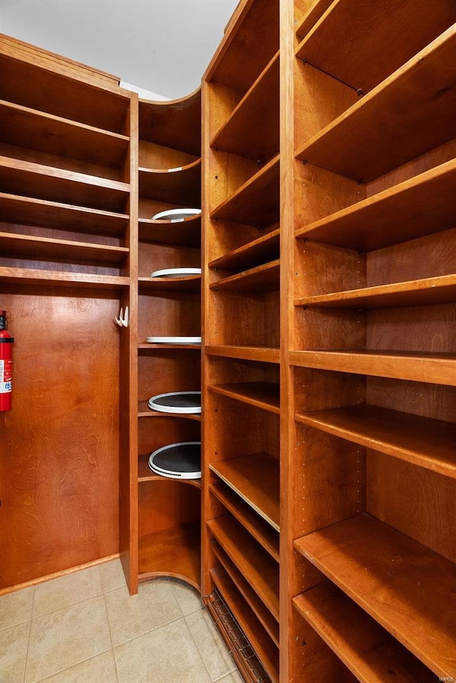 walk in closet with light tile patterned flooring