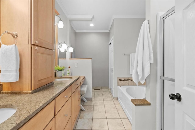 bathroom with double vanity, a bath, tile patterned flooring, crown molding, and a sink