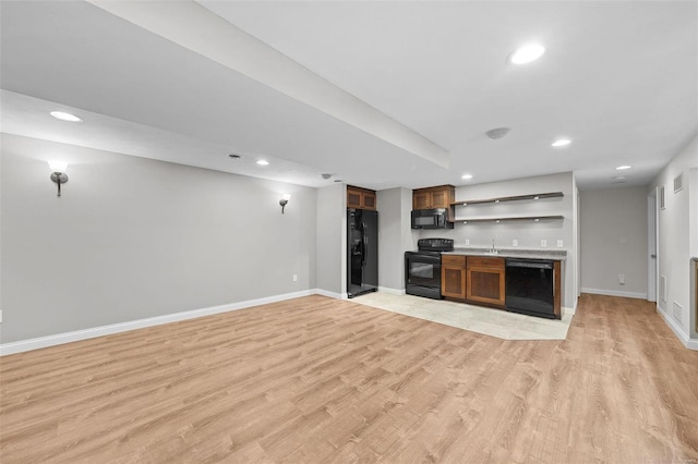 kitchen featuring light wood-style floors, baseboards, black appliances, and open shelves