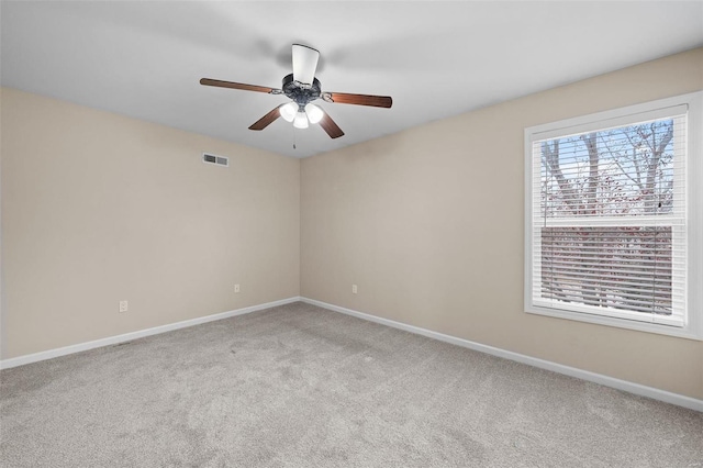 empty room featuring baseboards, visible vents, ceiling fan, and carpet flooring