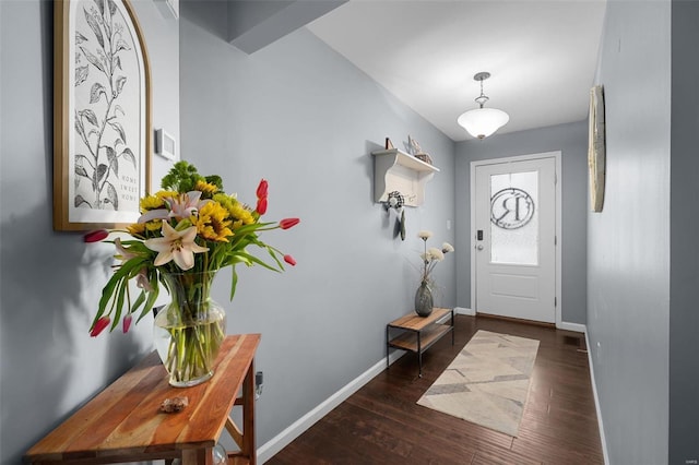 foyer entrance featuring wood finished floors and baseboards