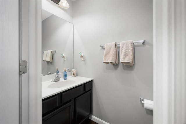 bathroom featuring baseboards and vanity