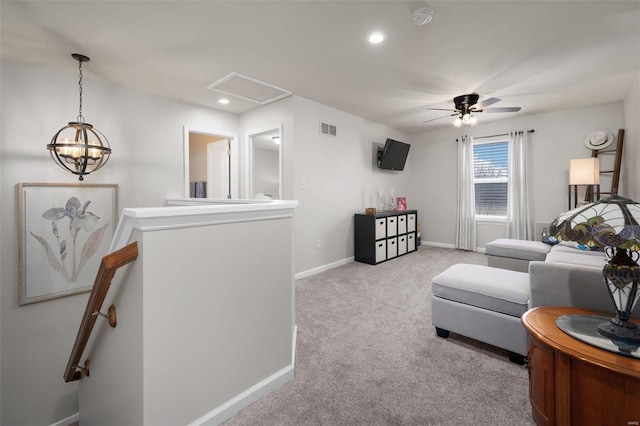 living area featuring baseboards, visible vents, an upstairs landing, carpet floors, and recessed lighting