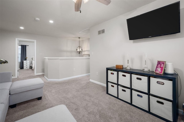 carpeted living area with a ceiling fan, recessed lighting, visible vents, and baseboards