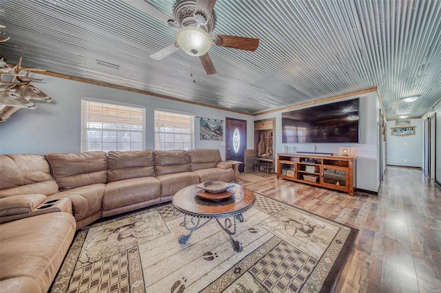 living room featuring visible vents, crown molding, wooden ceiling, hardwood / wood-style flooring, and a ceiling fan