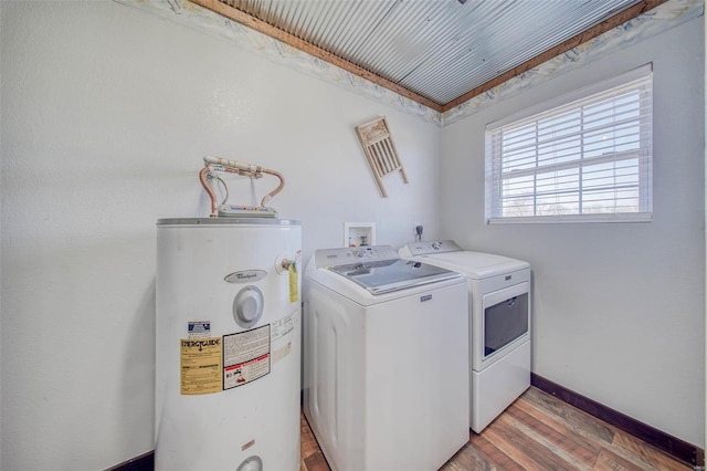 clothes washing area with baseboards, light wood-type flooring, water heater, laundry area, and independent washer and dryer