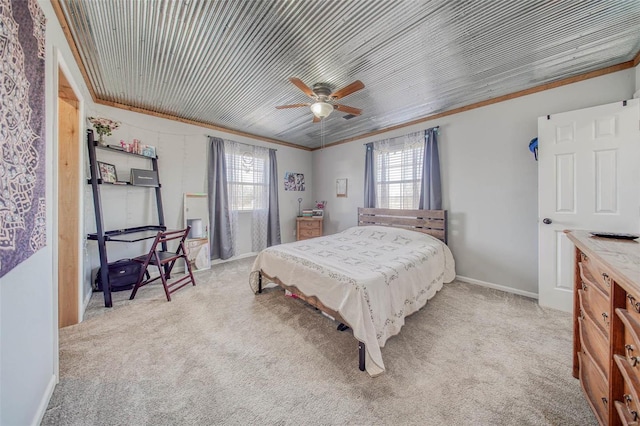 carpeted bedroom featuring multiple windows, ceiling fan, baseboards, and ornamental molding