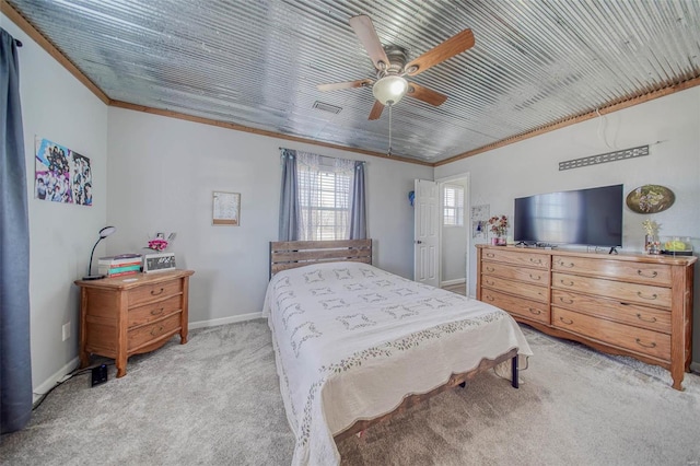 carpeted bedroom featuring visible vents, baseboards, a ceiling fan, and crown molding