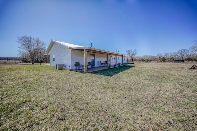 back of house with a yard, a patio, metal roof, and cooling unit