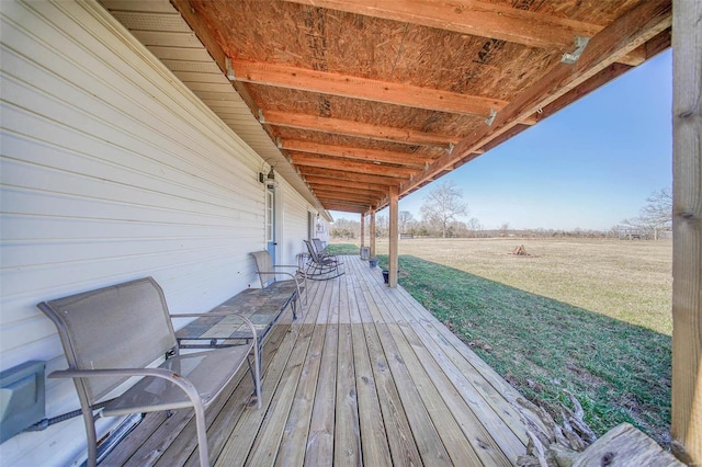 wooden terrace featuring a lawn