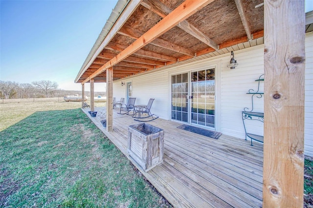 wooden deck featuring a lawn