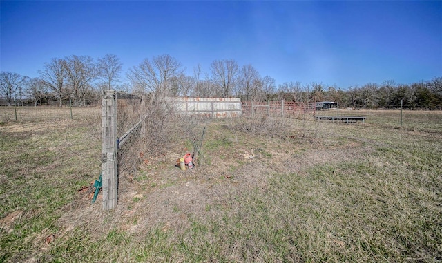 view of yard featuring a rural view and fence