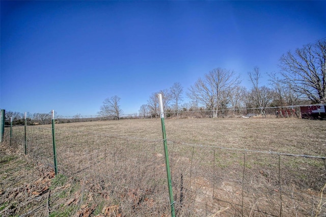 view of yard featuring a rural view and fence