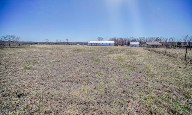 view of yard featuring a rural view and fence