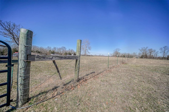 view of yard with a rural view and fence