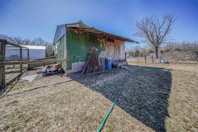 view of outbuilding with an outbuilding and fence