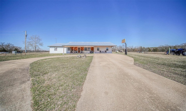 single story home featuring a porch, concrete driveway, and a front yard