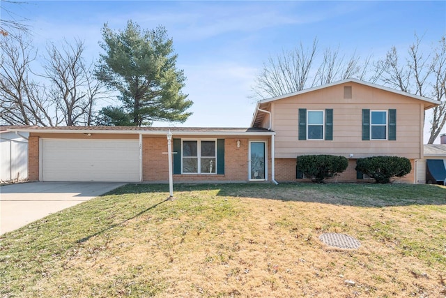 split level home featuring an attached garage, a front lawn, concrete driveway, and brick siding