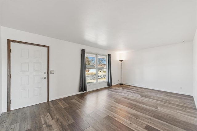 unfurnished room featuring wood finished floors and baseboards