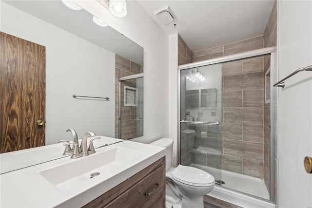 full bath with toilet, a shower stall, visible vents, and vanity