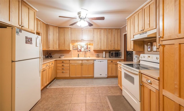 kitchen featuring white appliances, light countertops, under cabinet range hood, and light brown cabinetry