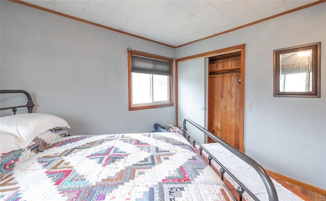 bedroom with a closet and crown molding