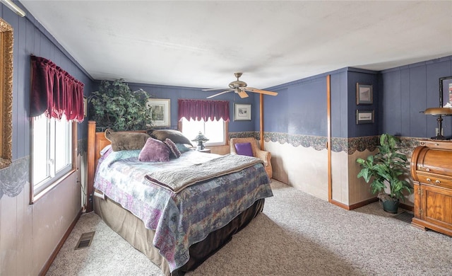 carpeted bedroom with visible vents and a ceiling fan