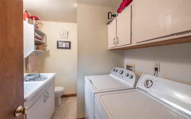 washroom with laundry area, baseboards, washing machine and clothes dryer, light floors, and a sink