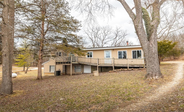 rear view of property featuring a deck