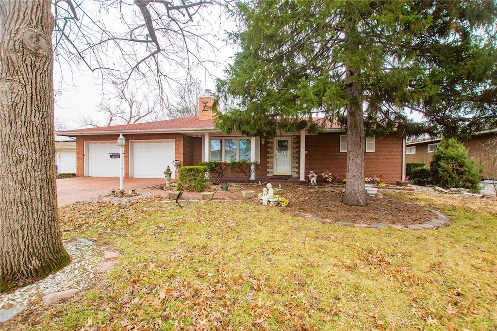 ranch-style home with driveway, an attached garage, a chimney, and brick siding