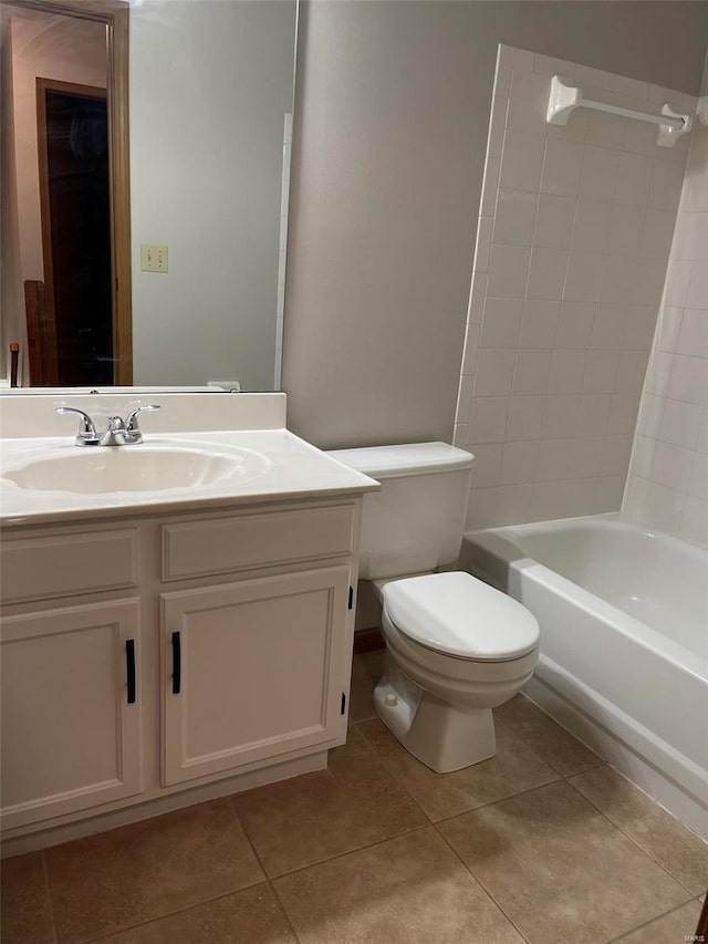 full bath with shower / bathtub combination, vanity, toilet, and tile patterned floors