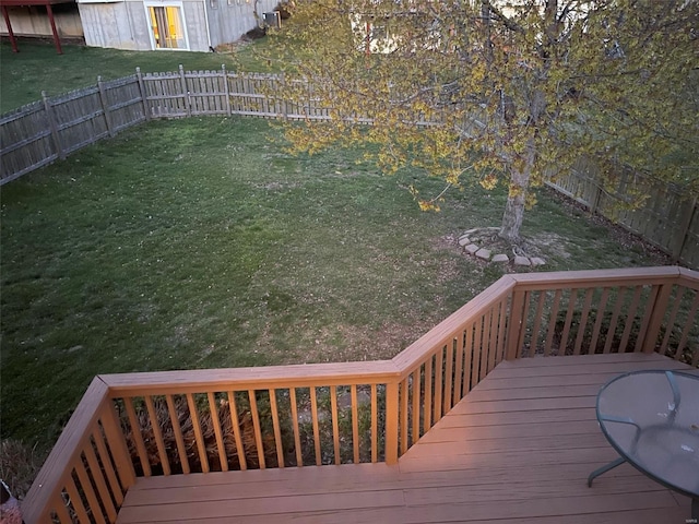 wooden terrace with a fenced backyard and a lawn