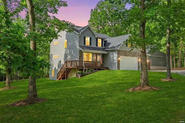 view of front facade featuring driveway, stairway, an attached garage, a deck, and a front lawn