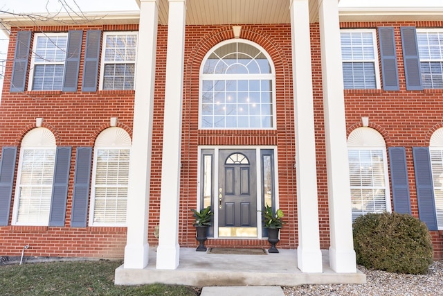 property entrance featuring brick siding