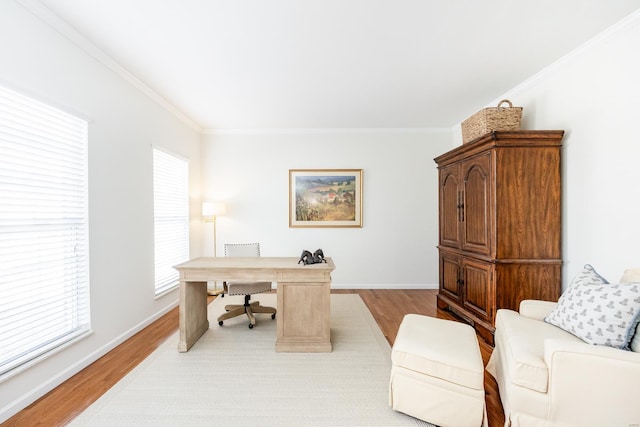 office space featuring ornamental molding, light wood-type flooring, and baseboards