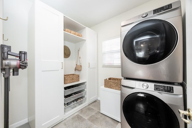 laundry area with laundry area and stacked washer / drying machine