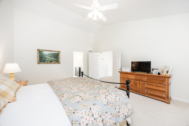 bedroom with light carpet, lofted ceiling, a ceiling fan, and baseboards