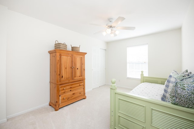 bedroom with baseboards, a ceiling fan, and light colored carpet