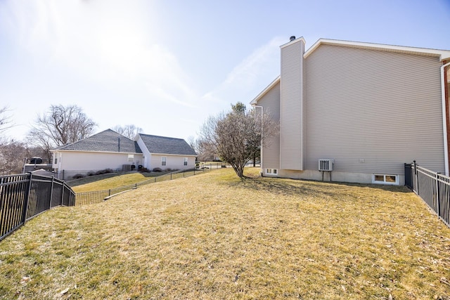 view of property exterior with a fenced backyard, a yard, and a chimney