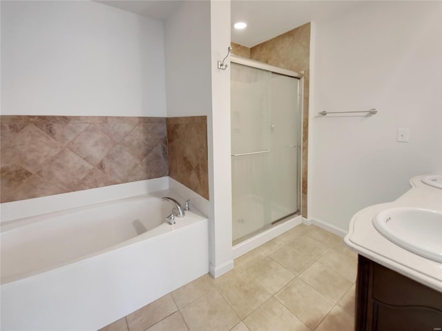 bathroom with baseboards, a garden tub, tile patterned flooring, vanity, and a shower stall