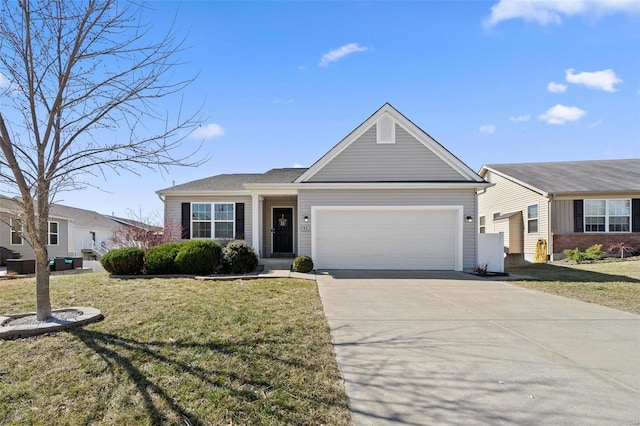 ranch-style house featuring a front lawn, an attached garage, and driveway